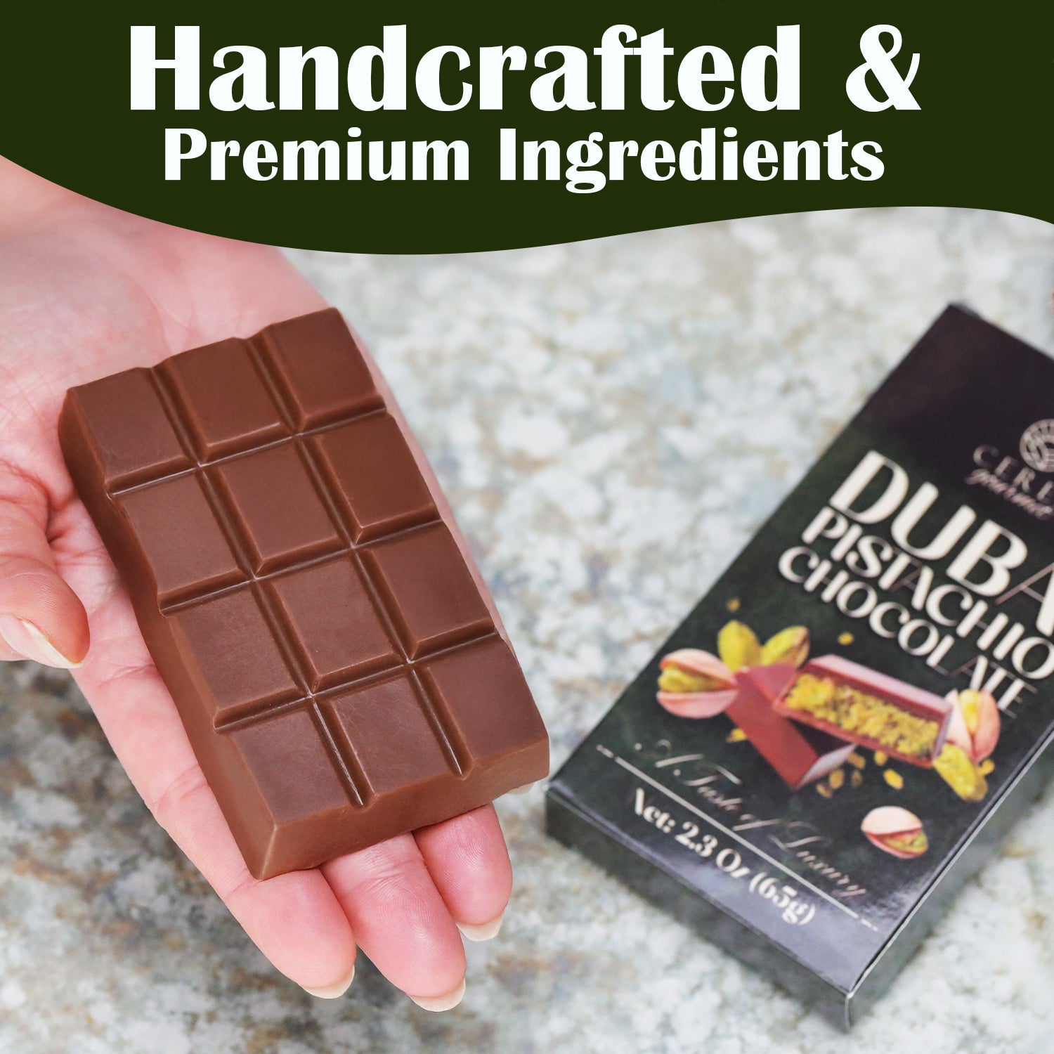 A hand holds the Ceres Gourmet Dubai Chocolate Pistachio Bar – 2.3oz (65g), with a box labeled Dubai Pistachio Chocolate and pistachios beside it. Handcrafted with premium ingredients for a truly luxurious chocolate experience.